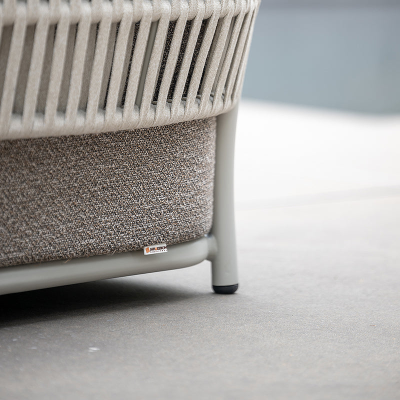 Close-up view of the intricate woven pattern and frame of a modern, minimalist outdoor chair, showcasing its elegant and durable design.